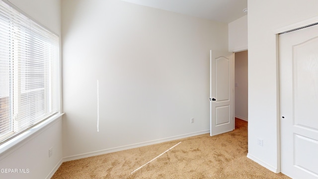 2237 Tony Harper St, El Paso, TX 79938 - unfurnished bedroom with baseboards and light carpet