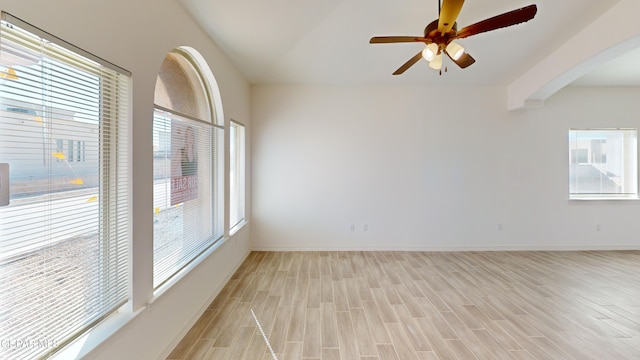 2237 Tony Harper St, El Paso, TX 79938 - unfurnished room featuring a wealth of natural light, light wood-type flooring, arched walkways, and a ceiling fan