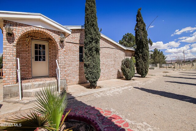 exterior space featuring brick siding
