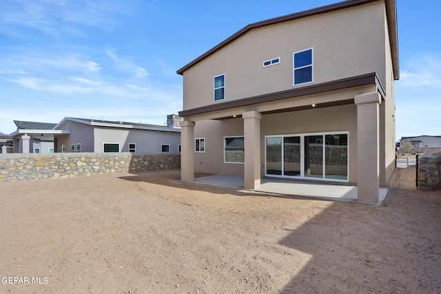 13095 Emerald Isle St, El Paso, TX 79928 - back of house with stucco siding and a patio area