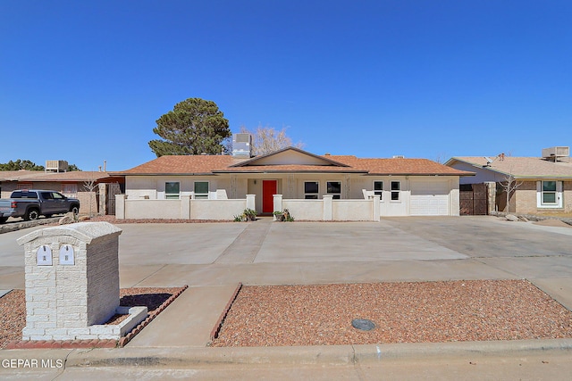 ranch-style house with fence, an attached garage, concrete driveway, stucco siding, and covered porch