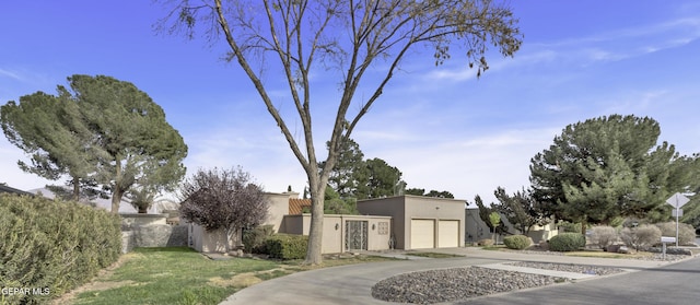 4945 Vista Grande Cir, El Paso, TX 79922 - view of front of property featuring fence, driveway, stucco siding, and a garage