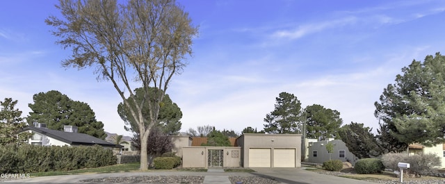 4945 Vista Grande Cir, El Paso, TX 79922 - view of front facade featuring a garage, driveway, and stucco siding