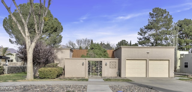 4945 Vista Grande Cir, El Paso, TX 79922 - view of front of property with driveway, fence, a tiled roof, a gate, and stucco siding
