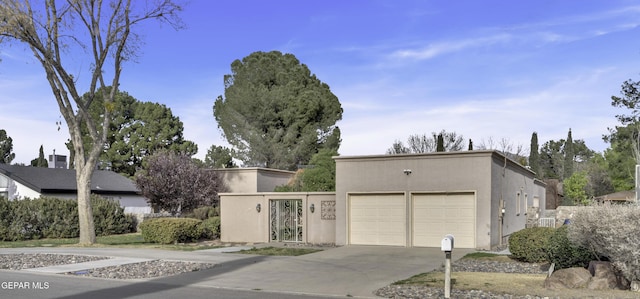 4945 Vista Grande Cir, El Paso, TX 79922 - view of front of house with a garage, concrete driveway, and stucco siding