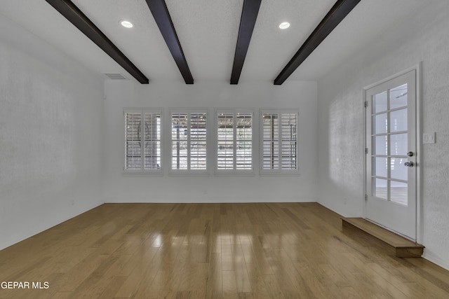 4945 Vista Grande Cir, El Paso, TX 79922 - interior space with visible vents, a healthy amount of sunlight, beam ceiling, and wood finished floors