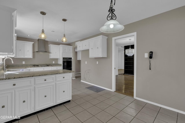 4945 Vista Grande Cir, El Paso, TX 79922 - kitchen featuring a sink, light tile patterned flooring, black oven, light stone counters, and wall chimney exhaust hood