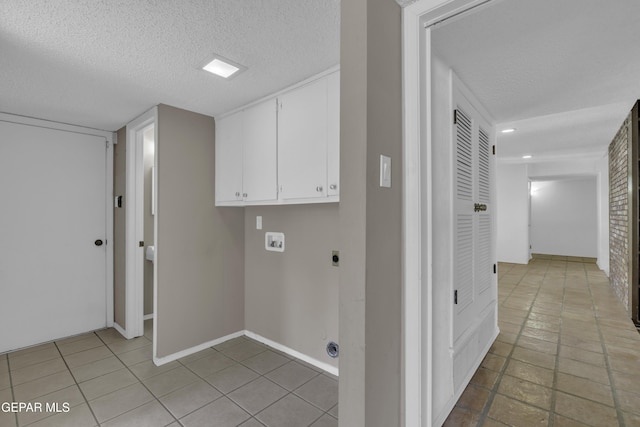 4945 Vista Grande Cir, El Paso, TX 79922 - laundry area with hookup for an electric dryer, washer hookup, cabinet space, and a textured ceiling