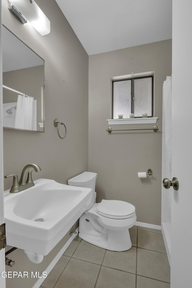 4945 Vista Grande Cir, El Paso, TX 79922 - bathroom featuring baseboards, a shower with shower curtain, toilet, and tile patterned flooring