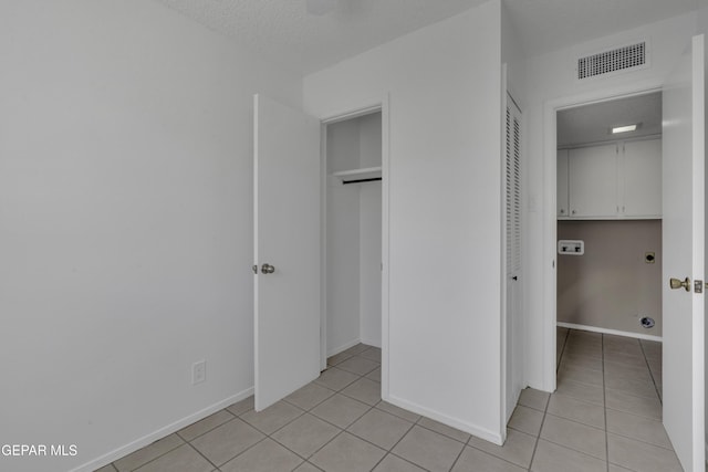 4945 Vista Grande Cir, El Paso, TX 79922 - unfurnished bedroom featuring light tile patterned floors, a textured ceiling, baseboards, and visible vents