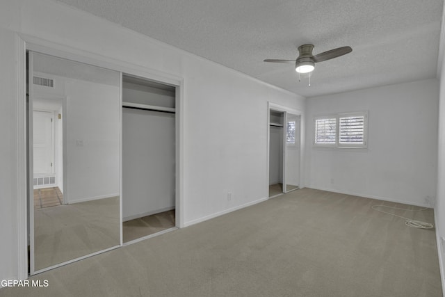 4945 Vista Grande Cir, El Paso, TX 79922 - unfurnished bedroom with two closets, carpet floors, a textured ceiling, and visible vents