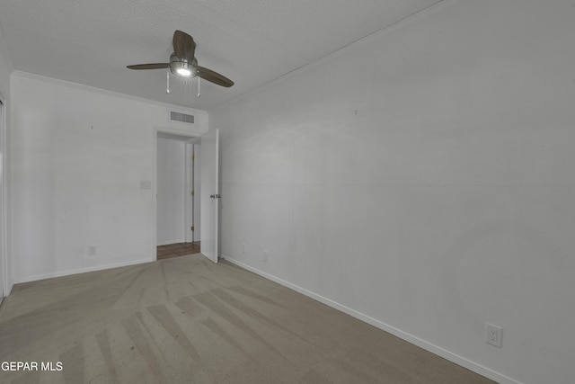 4945 Vista Grande Cir, El Paso, TX 79922 - spare room with a textured ceiling, visible vents, crown molding, a ceiling fan, and carpet floors