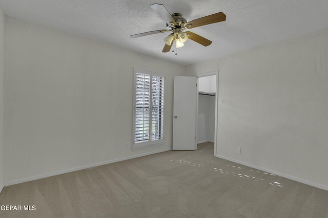 4945 Vista Grande Cir, El Paso, TX 79922 - unfurnished bedroom with light colored carpet, a ceiling fan, baseboards, and a textured ceiling