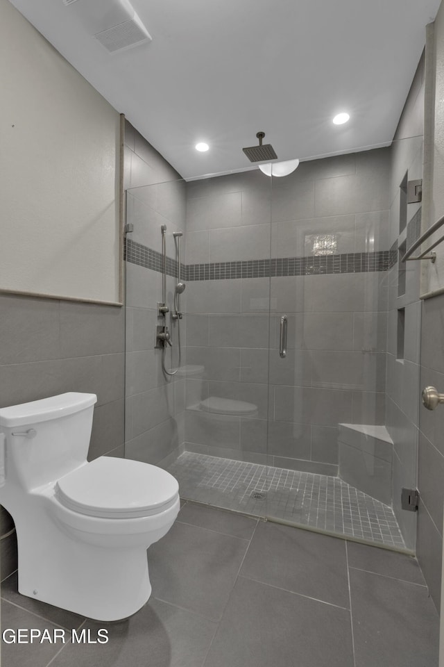 4945 Vista Grande Cir, El Paso, TX 79922 - bathroom featuring tile patterned flooring, tile walls, recessed lighting, toilet, and a stall shower