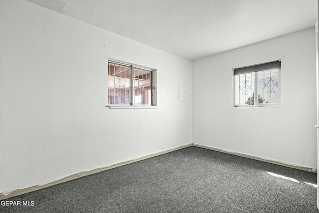 9005 Electra Dr, Canutillo, TX 79835 - spare room featuring a healthy amount of sunlight, carpet flooring, and baseboards