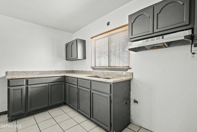 9005 Electra Dr, Canutillo, TX 79835 - kitchen featuring gray cabinets, under cabinet range hood, light tile patterned floors, and light countertops