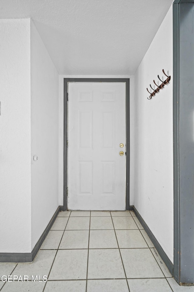 9005 Electra Dr, Canutillo, TX 79835 - interior space featuring a textured ceiling, light tile patterned floors, and baseboards