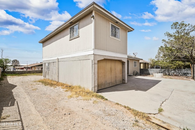 9005 Electra Dr, Canutillo, TX 79835 - view of side of home with fence, a garage, and driveway