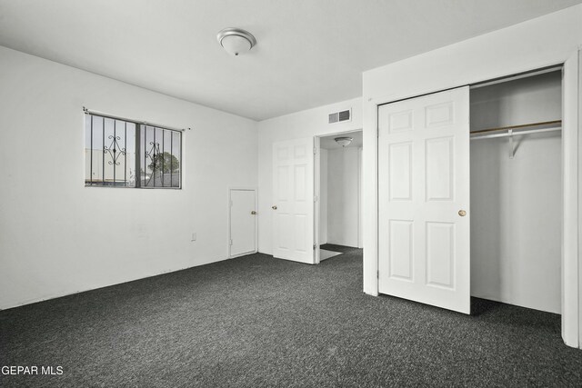 9005 Electra Dr, Canutillo, TX 79835 - unfurnished bedroom featuring a closet, dark colored carpet, and visible vents