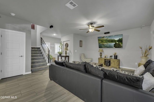 221 Ilchester Way, El Paso, TX 79928 - living area with visible vents, light wood finished floors, baseboards, ceiling fan, and stairway