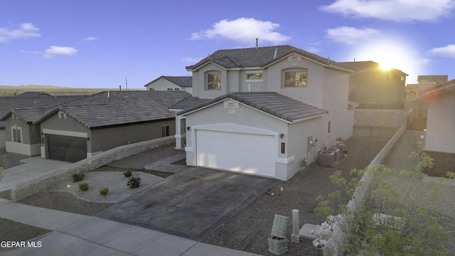 221 Ilchester Way, El Paso, TX 79928 - view of front of home with a tiled roof, concrete driveway, stucco siding, and central air condition unit