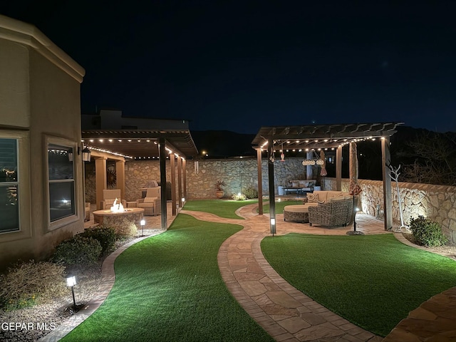 yard at twilight featuring a pergola, a fenced backyard, an outdoor living space with a fire pit, and a patio