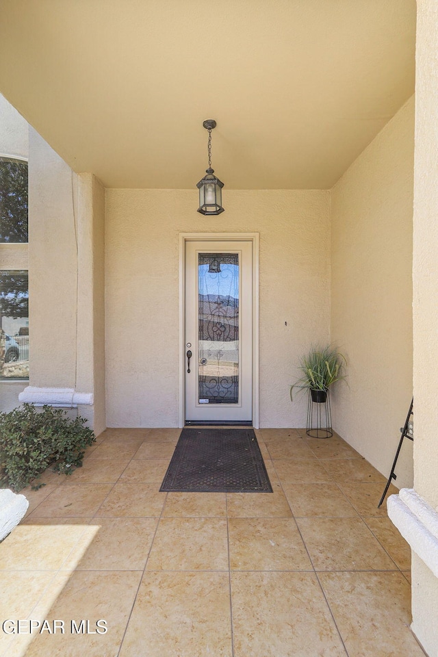 entrance to property with stucco siding