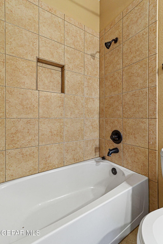 bathroom with toilet and tub / shower combination