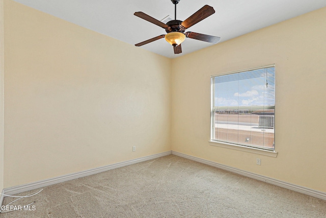 unfurnished room with baseboards, a ceiling fan, and light colored carpet