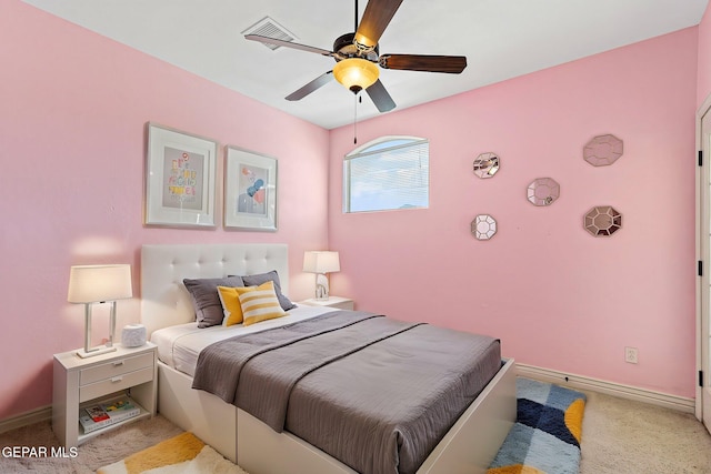carpeted bedroom with baseboards, visible vents, and a ceiling fan