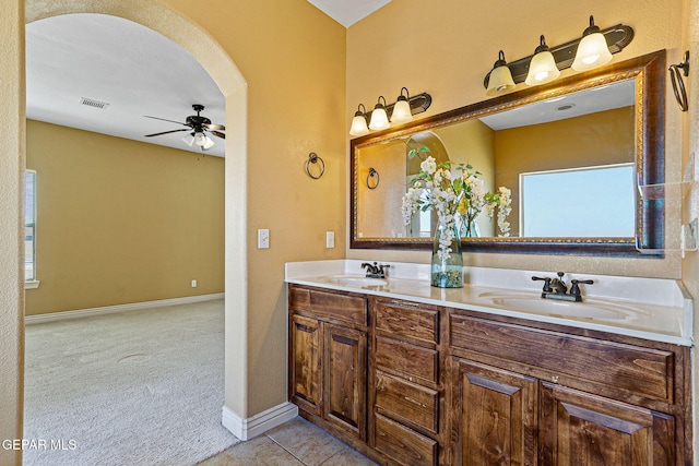 bathroom with a ceiling fan, a sink, double vanity, and visible vents