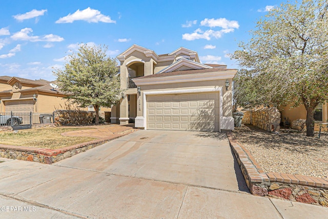 view of front of home featuring concrete driveway, stucco siding, fence, and an attached garage