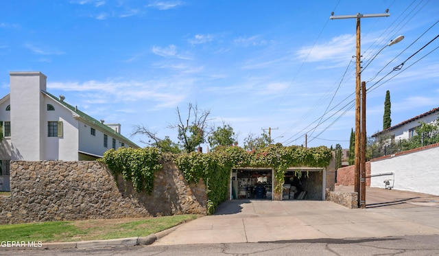 view of front of home featuring stucco siding and fence
