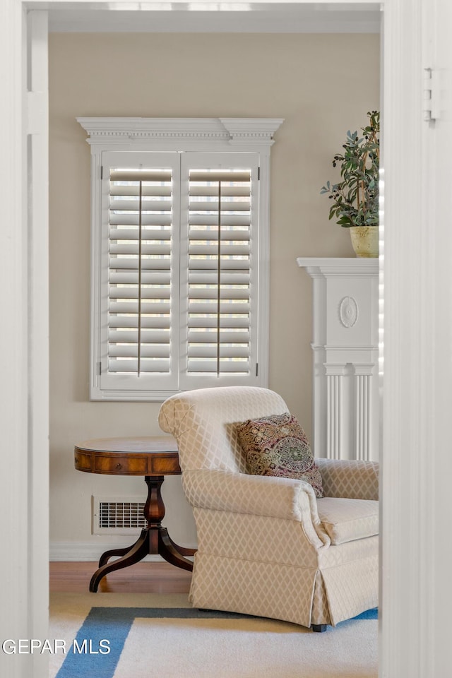 sitting room with visible vents and wood finished floors