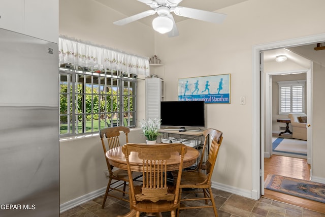 dining space featuring baseboards and ceiling fan