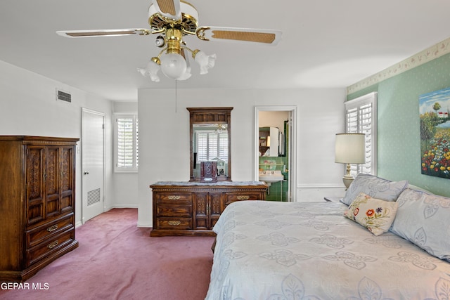 bedroom featuring ensuite bathroom, baseboards, visible vents, and carpet