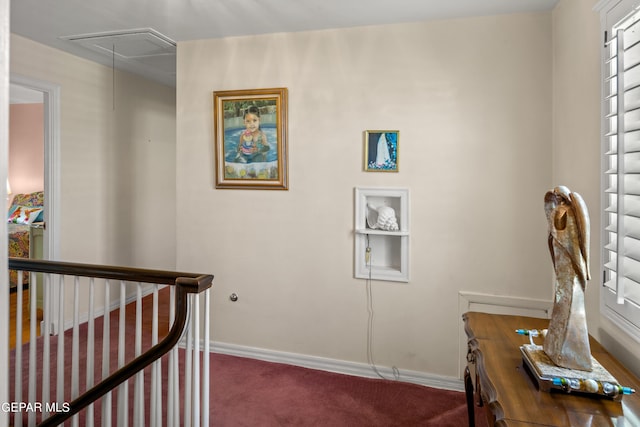 carpeted office featuring attic access and baseboards