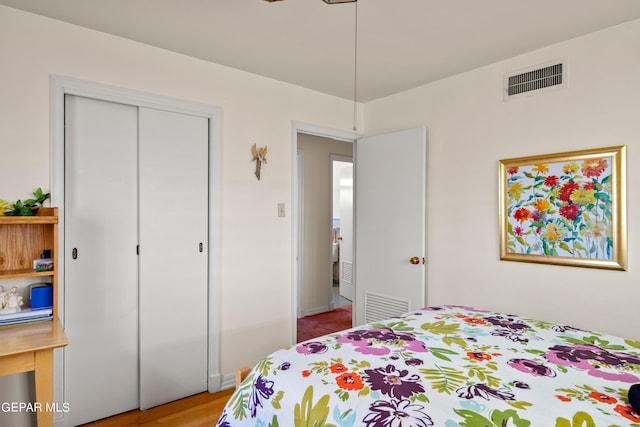 bedroom featuring visible vents and a closet