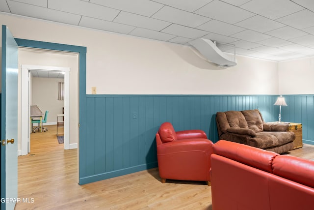 sitting room featuring light wood-style flooring and wainscoting