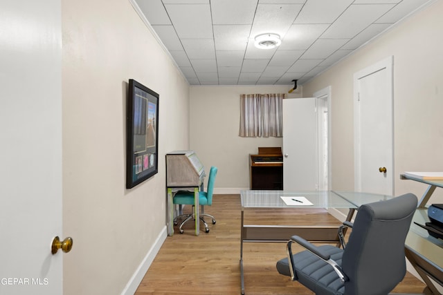 office area featuring baseboards and wood finished floors
