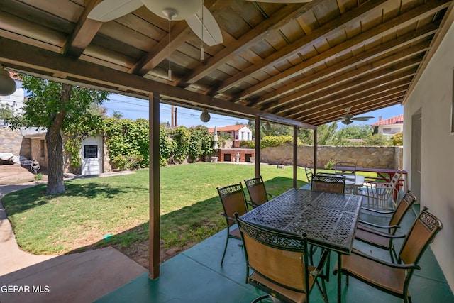 view of patio with outdoor dining space and a ceiling fan