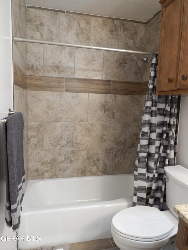 bathroom with shower / tub combo and toilet