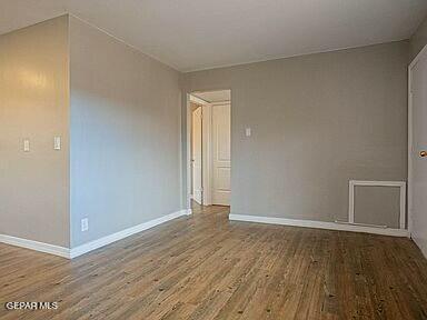 8718 Lawson St Unit 9, El Paso, TX 79904 - unfurnished room with baseboards and wood finished floors