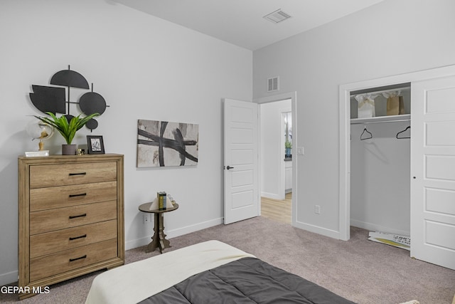 bedroom with carpet floors, a closet, baseboards, and visible vents