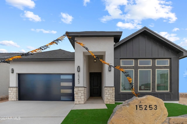 15253 Gauge Ct, El Paso, TX 79938 - view of front of property featuring stone siding, driveway, board and batten siding, a garage, and stucco siding