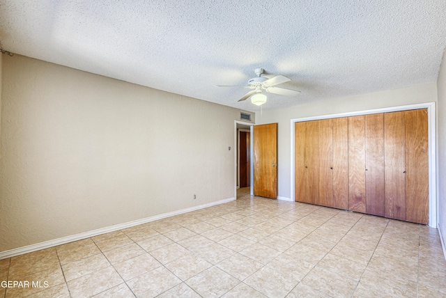 unfurnished bedroom featuring baseboards, ceiling fan, a closet, and visible vents
