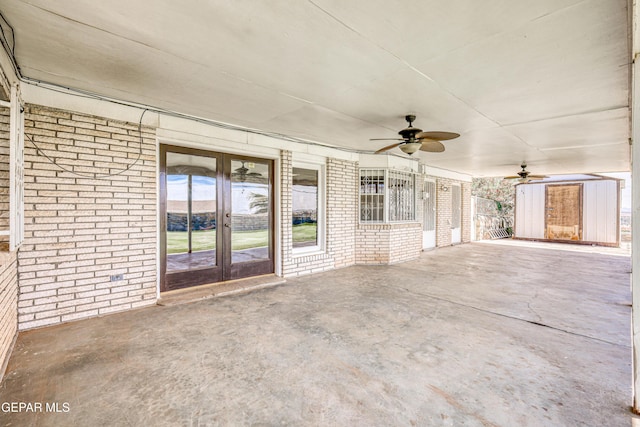 view of patio featuring french doors, ceiling fan, and a storage shed