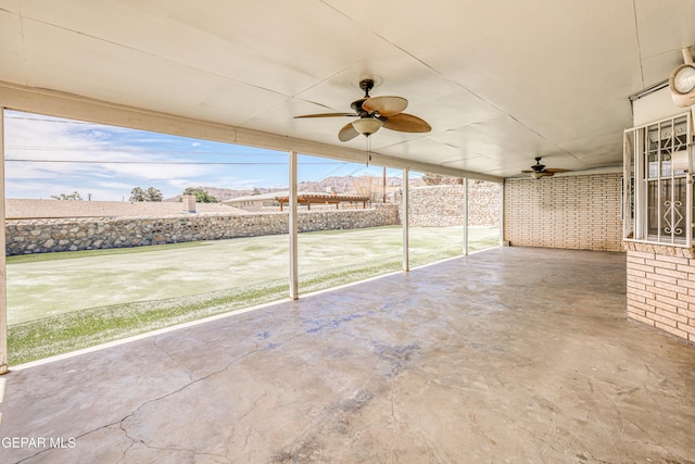 view of patio with fence and a ceiling fan
