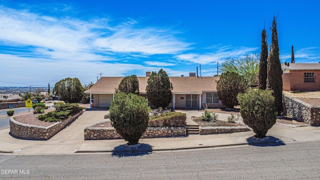 single story home with concrete driveway