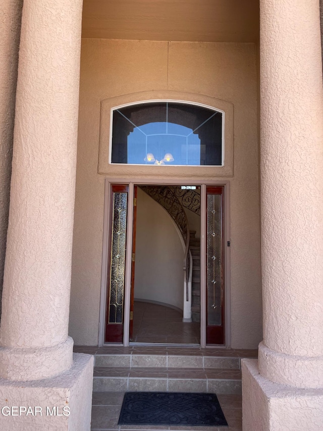 property entrance with stucco siding